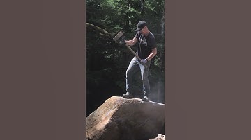 Splitting massive rock in half with a sledgehammer