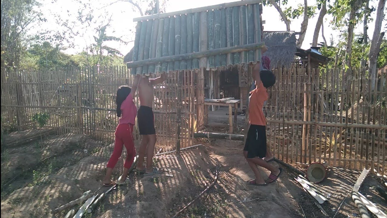 making bamboo fence together,a family effort