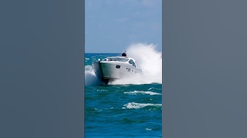Pershing Power Yacht named JUSTUS with rooster tail makimg a grand entrance at the Haulover Inlet