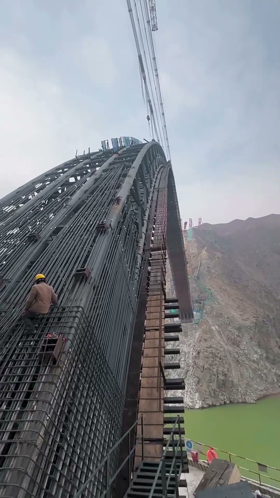 Welding process of arch steel bridge across river- Good tools and machinery make work easy