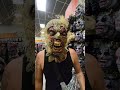 Robbie trying on wicked scarecrow full mask and big knife  shopping spirit halloween costume ideas