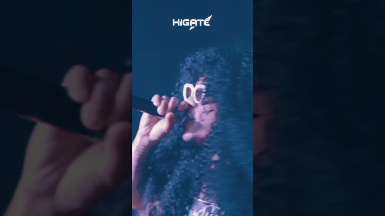 A performer under blue stage lighting at SF Hip Hop and Unity Suppers