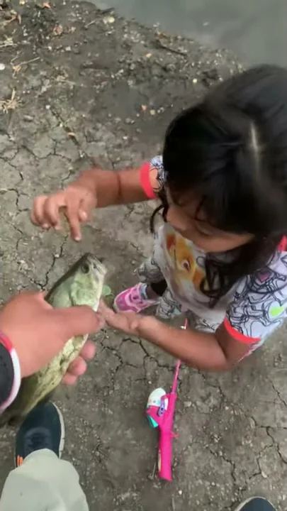 Cute little girl catches first fish