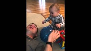 Took your pillow! Baby plays trick on daddy, giggling uncontrollably!