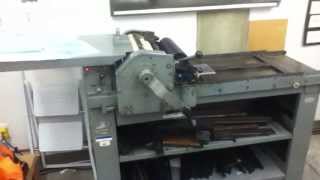 Printing a linoblock on a Vandercook press.