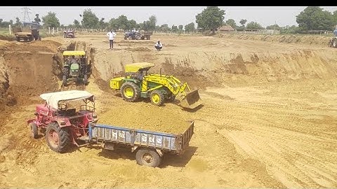 Loading unloading clay bucket loader mounted on tractor