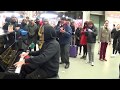 Crowd Digs Christmas Blues at a Public Piano