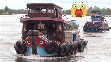 Hai tàu kéo dũng mãnh kéo sà lan khổng lồ vượt cống hấp dẫn