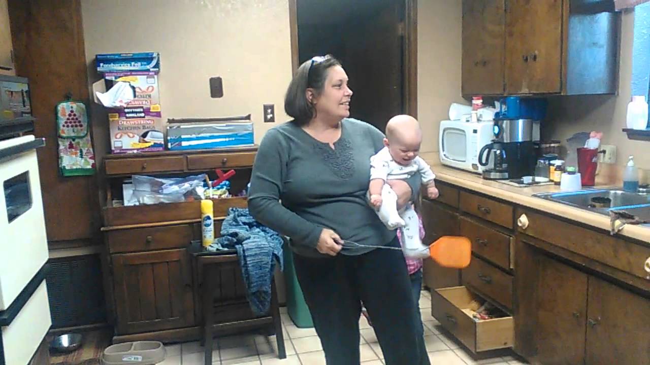 Baby laughing at fly swatter