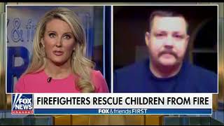 Hero firefighter catches baby dropped from burning building