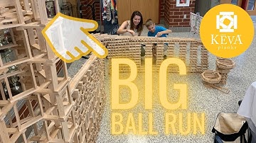 Boy creates massive KEVA Planks ball run!