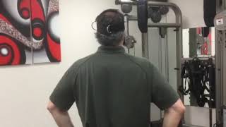 Dynamic cervical stabilization with reverse walk for neck strengthening using the Total Neck Trainer