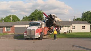 Tree trimming truck loses balance, falls into southern Indiana home