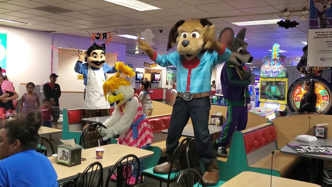 Chuck-E-Cheese and friends dancing on tables.... 