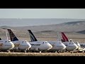Airplane graveyard with Boeing 747s and other aircraft parked in Mojave Desert, California (2 clips)