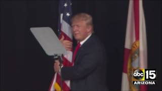 Donald Trump takes the stage and hugs an American flag in Tampa, Florida