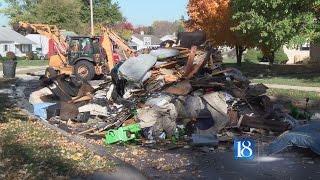 Fire inside trash truck causes driver to dump load
