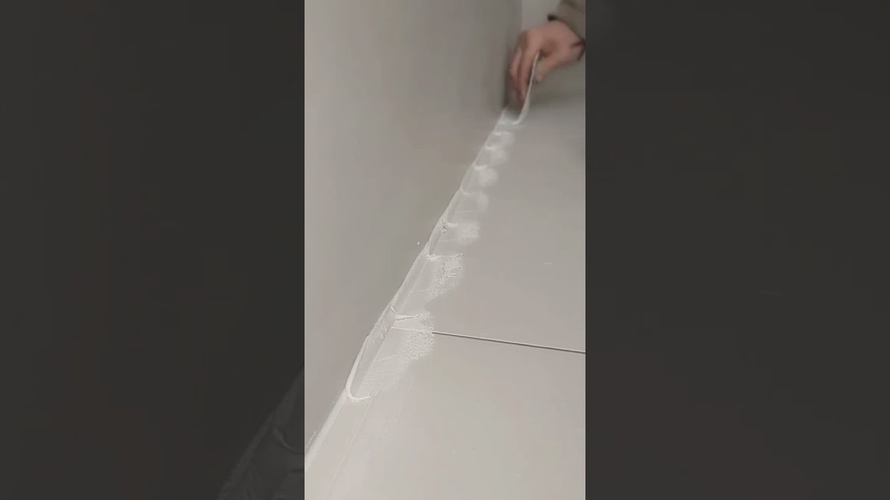 Apply grout to the floor tiles on the edges and smooth it out. 