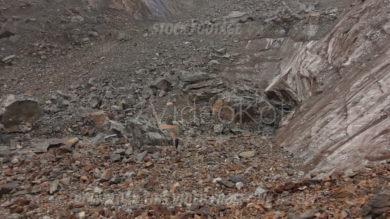 Isolated highaltitude rocky glacier area, Untouched rugged terrain with scattered stones and snow