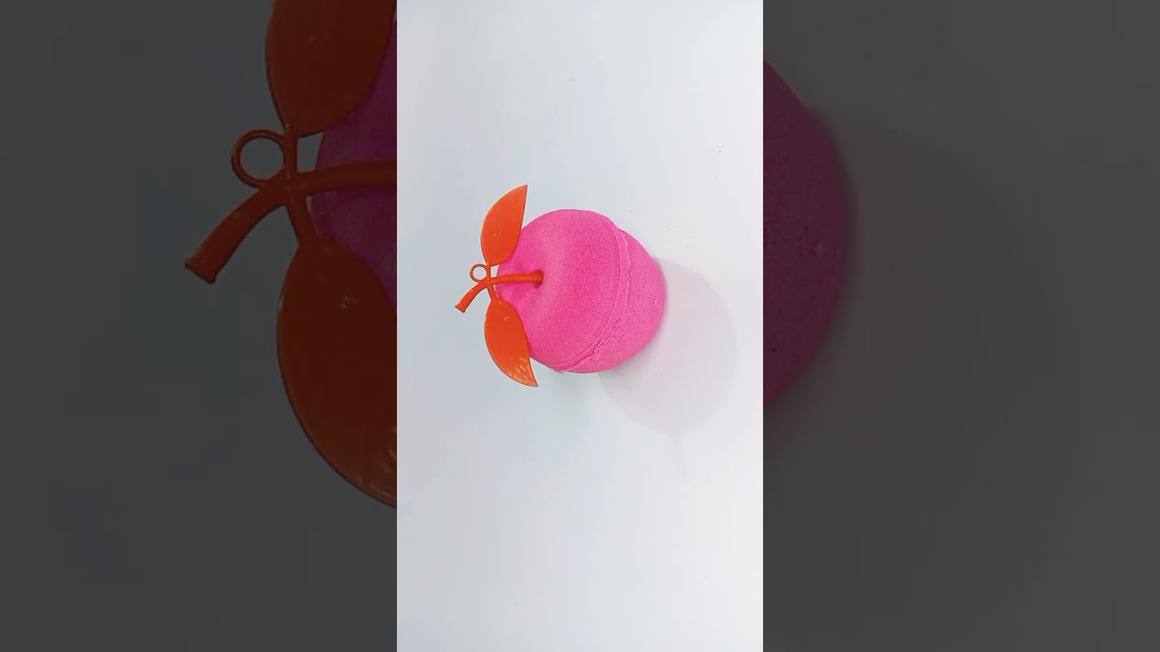 Pink apple kinetic sand cutting