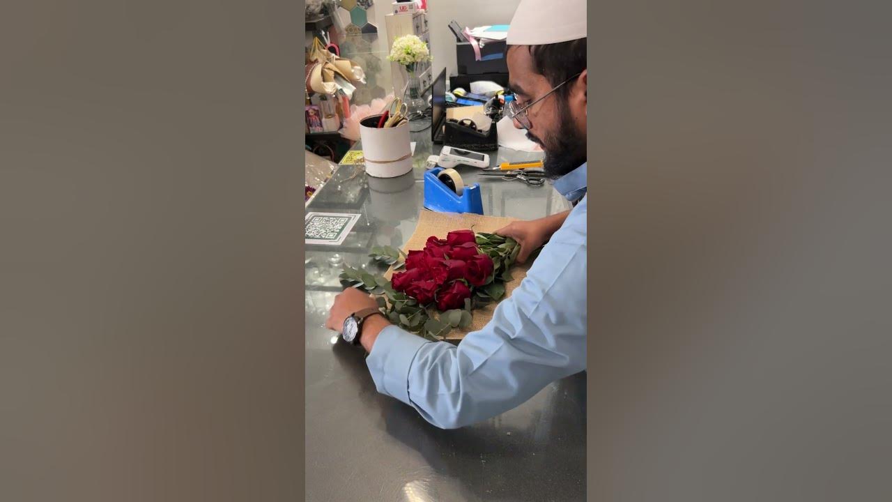 Red roses wrapped in a natural burlap and tied with a red ribbon🌹#@Flowershop007