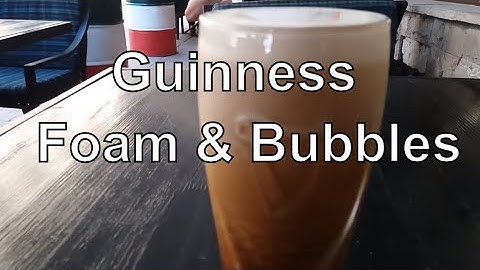 Guinness Beer. Foam & Bubbles Flowing Down