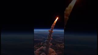NASA's SLS rocket roars to life under Earth's watchful eye from orbit. #NASALaunch #SpaceSerenity