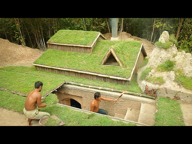Building underground hut with grass roof & fireplace with clay class=