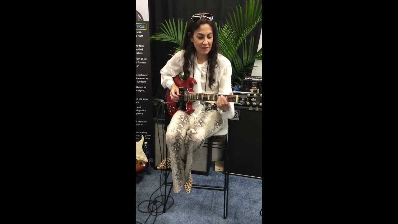 Lez Zeppelin's Steph Paynes tries out the PowerWire TS09 Active Guitar Cable at NAMM