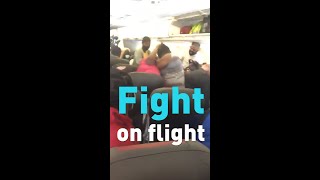 Watch American Airlines passengers fight on a plane over masks.