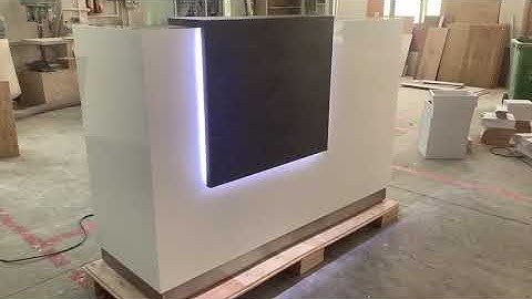 White Corian stone wooden panel reception desk with led