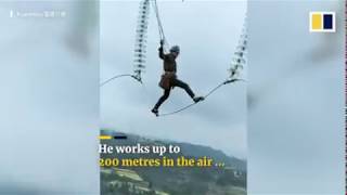 Chinese Man walking on high voltage electric cables