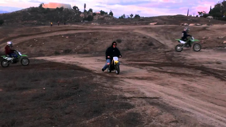 Krista riding Malachi's dirt bike.