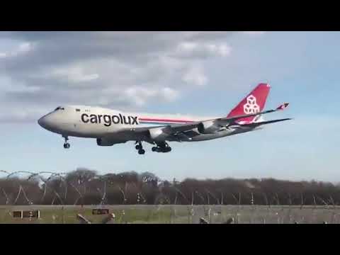 Engine pod of a Boeing 747 strikes runway during landing forcing the crew to perform a go around