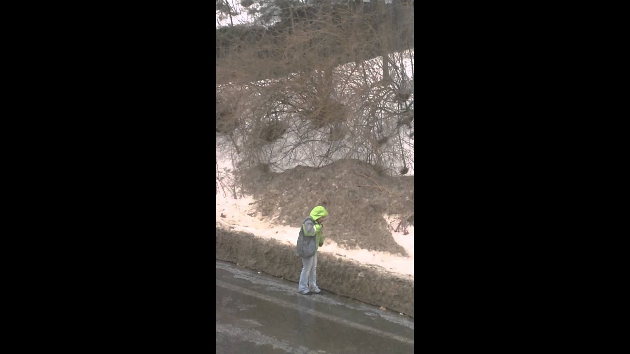 Girl slipping on ice in freezing rain, but at least her Dunkin' in safe
