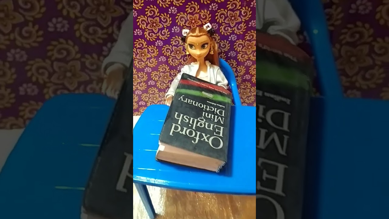 cute doll reading dictionary 