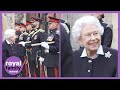 The queen giggles with canadian officers  