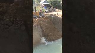 Bulldozer pushing The Soil Into The Water