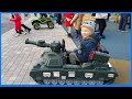 My son controlled the toy tank in children&#39;s playground. Toy tank for kids and toddlers.