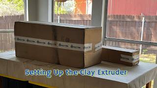 Clay 3D printing setup in progress (Unboxing → Loading → Installing)