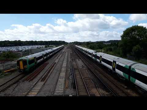 2 Class 377s passing Gatwick Airport on a sunny day