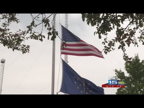 Flags fly at