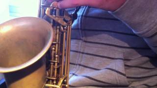 Ernesto Aurignac plays saxophone at home