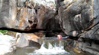 Vicky jumping into the pot hole at Glade Park