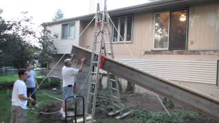 Using a pulley system to hoist a big steel beam for a sunroom