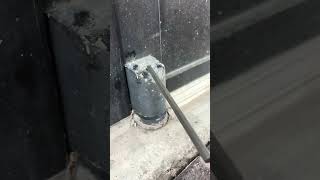 Bottom Pivot Hinge adjustment on a Storefront Glass Door. Bottom Pivot Hinge adjustment on a Storefront Glass Door.