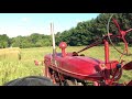 Farmall H with straight pipe brush hogging