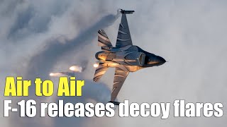 Air to Air:F-16 rolls and releases decoy flares