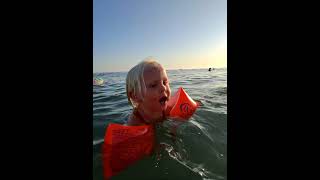 A Little Girl Swimming In The Sea