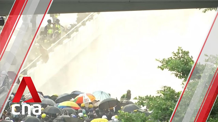 Hong Kong police fire water cannons and tear gas at protesters outside Legislative Council